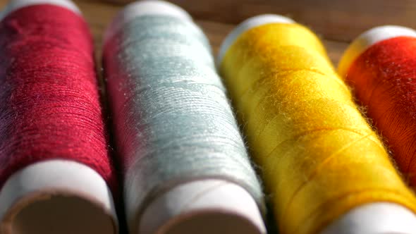 Spools of Colored Thread Close-up. Textile Industry. Sew with a Needle and Thread. Embroider on