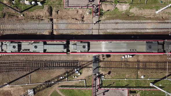 Top View of a Dangerous Railway Crossing in the City. People Walks on Rails alt