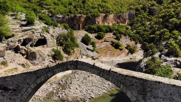 AERIAL Flying Under an Ancient Arched Stone Bridge in Albania