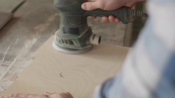 Carpenter Uses a Grinding Machine to Align