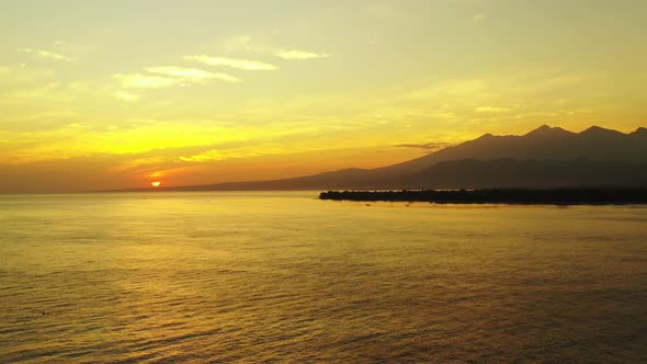 sunset over the beautiful philippine lagoon with small fishing boats in the foreground and mountains alt