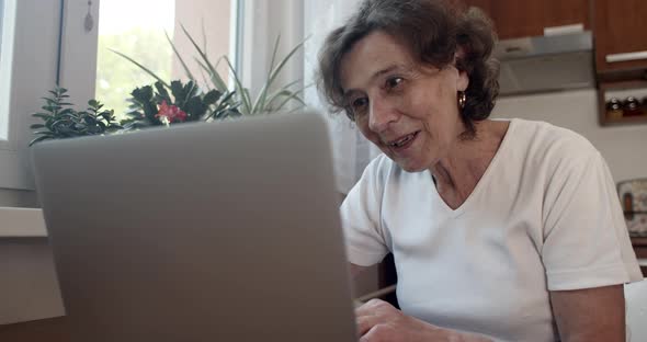 Senior Woman Chatting Online on Laptop 