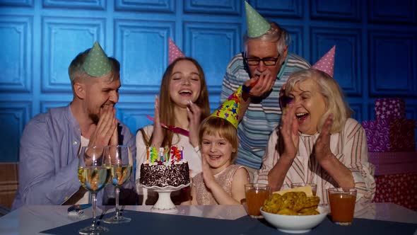 Girl Kid Blowing Candles on Cake Making Wish Having Fun Celebrating Birthday Party with Family alt