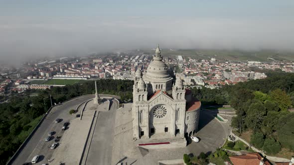 Orbital view of Santa Luzia church sanctuary on hilltop of Viana Do Castelo, Portugal on cloudy day. alt