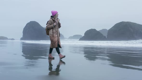 Scenic Oregon Coast Beach on Overcast Cloudy Gray Day Woman Walking By Beach alt