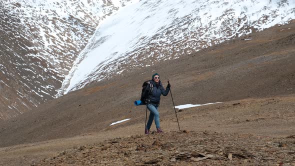 Explorer Female with Backpack Hiking in Mountains alt