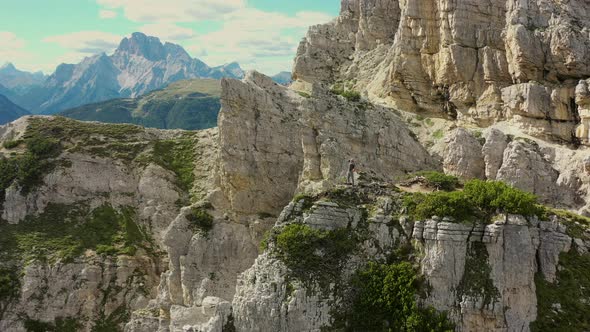 Successful Men in the Perfect Mountain Location with Hand Keeping Up in Victory alt