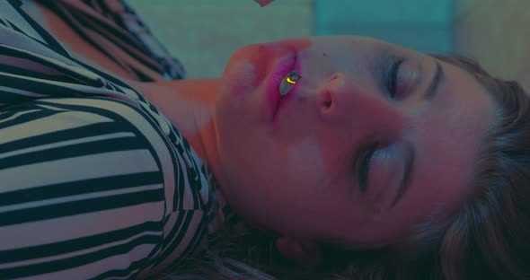 addiction, problems - sad girl eagerly smokes a joint staring at camera - macro alt