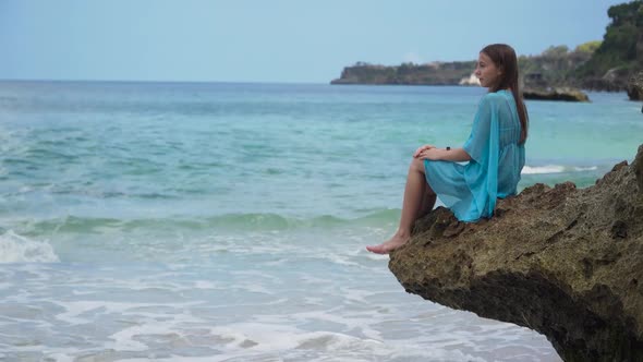 Girl Sitting on a Rocks alt
