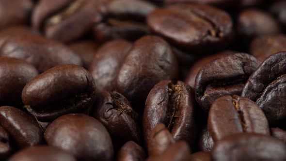 close up of roasted coffee beans rotating, seeds of coffee