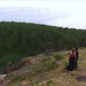 a man and a girl in love stand on a high rock on the river bank 05 - VideoHive Item for Sale