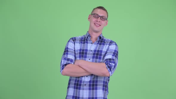 Happy Young Hipster Man Smiling with Arms Crossed