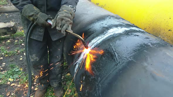 The Welder Cuts a Large Pipe with Acetylene Welding for Gasification