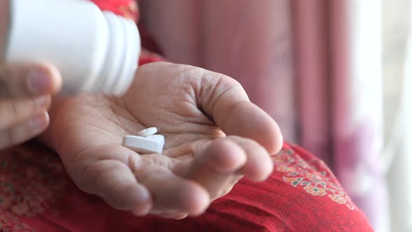 Close Up of Women Hand Taking Pills  alt