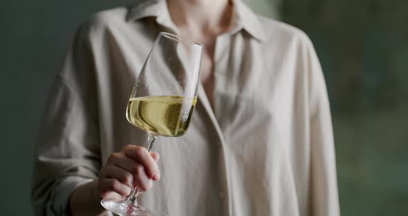 Girl with a Glass of White Wine in Her Hands