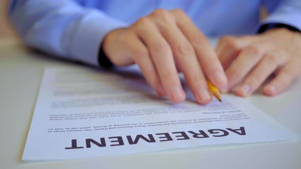 Serious Businessman Reading Purchase Agreement alt