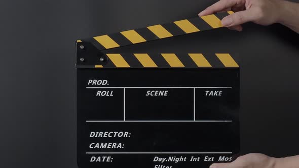 Movie clapperboard footage. Man hand holding film slate and clapping it in studio before shooting alt