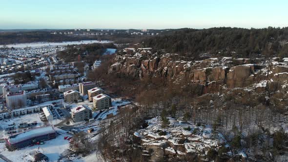 Mountain and Snow Covered Urban Residential Buildings Winter Aerial