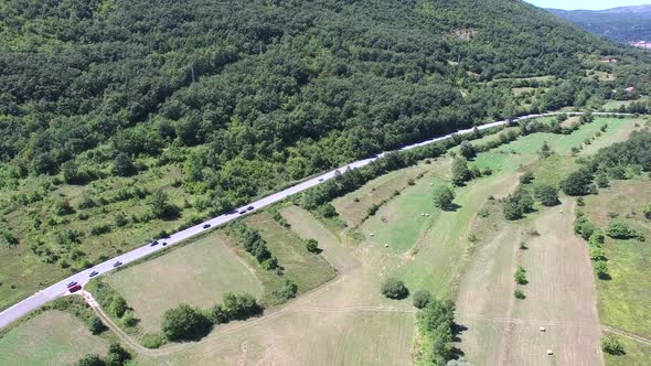 Aerial view of highway through green forested hills, Croatia alt