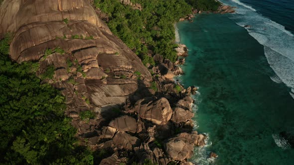 Aerial dolly tilt up over south end of beach Anse Source d'Argent