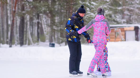 Family with Little Daughter Skates Walking Around on Rink alt