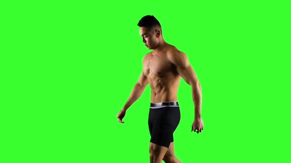Sportsman Walks and Runs on a Treadmill. Green Screen Studio alt
