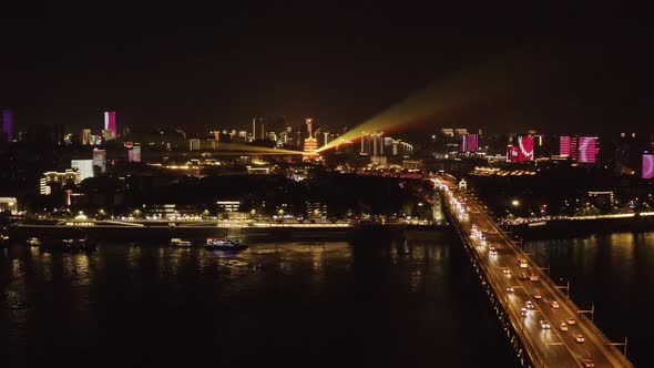 Aerial view of Yangtze River bridge at night in Wuhan downtown, China. alt