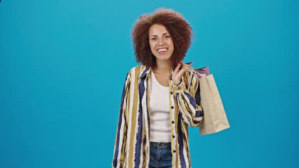 African American Woman Holds Paper Bags After Shopping alt