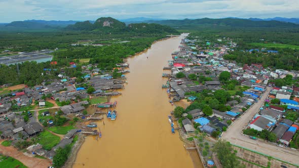 Aerial shot of river and local fisherman village beside the sea alt