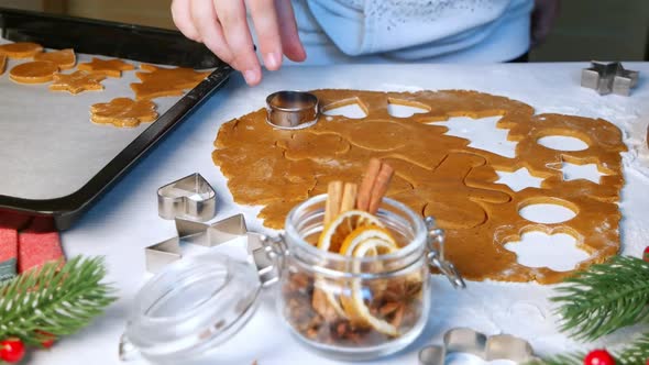 Making gingerbread cookies. Child cuts circle and put it on baking sheet