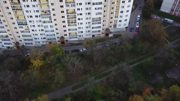 Aerial view of a drone flying over the residential buildings, roof shooting and architecture. alt