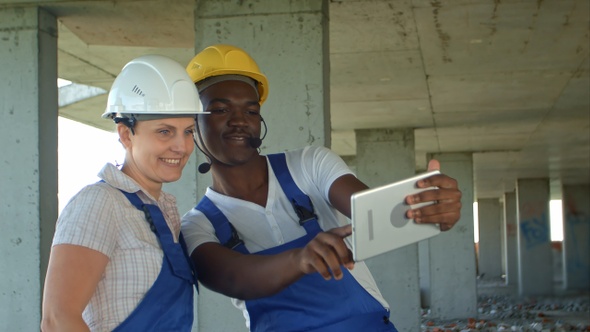 Funny workers taking selfie at contruction site