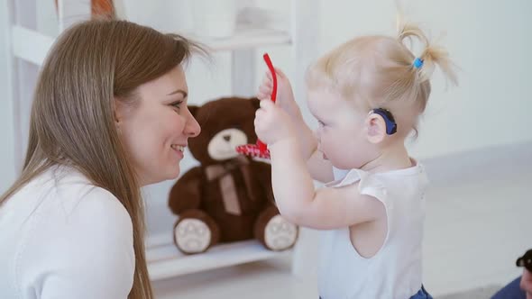 Concept of Hearing Impairment and Their Treatment. Cute Little Girl with a Hearing Aid alt