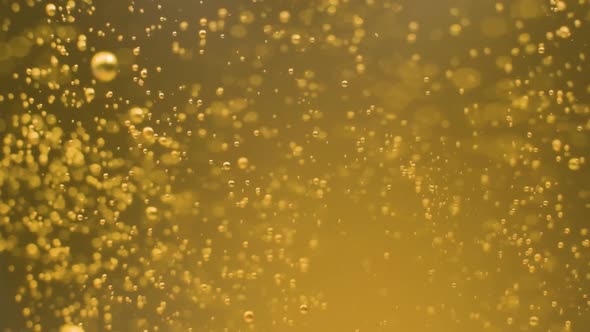 Extreme macro shot golden drink Bubbles explosion in slow motion, Concept alt