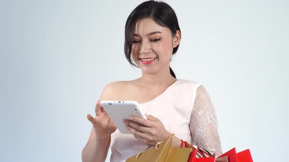 young woman shopping and using digital tablet