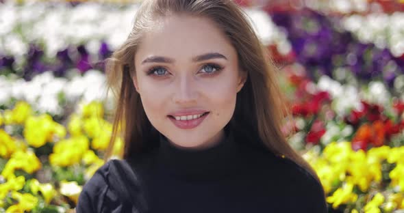 Portrait of Young and Beautiful Woman with Makeup Looking at Camera alt