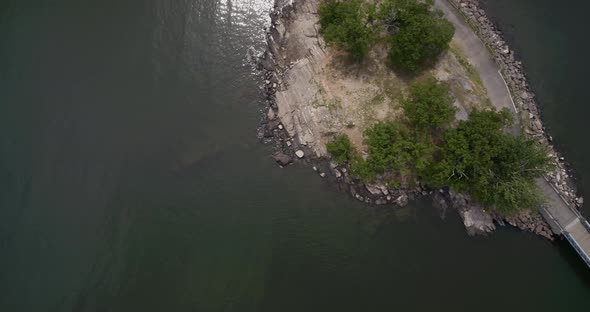 Top Down Aerial of a Lake and a Bridge Connected to a Small Island alt