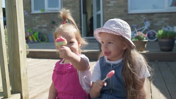 Two Sisters Children Enjoys Delicious Ice Cream Cone