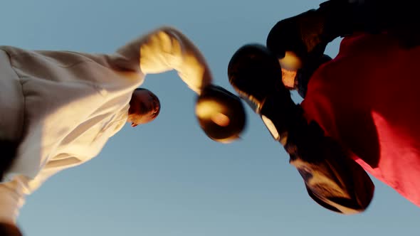Two Black Men Training Boxing Against Background Sunset Outdoors Bottom View alt