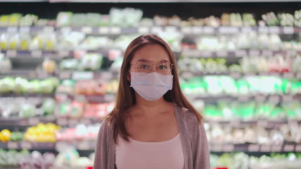 Young asian women wearing surgical mask in grocery store at supermarket