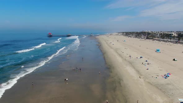 Aerial View of Huntington Pier, Beach and Coastline During Sunny Summer Day alt