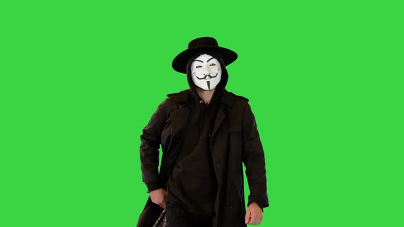 Anonymous Public Activist Hacker or Hacktivist Walk Dressed in Black Clothes and White Face Mask on