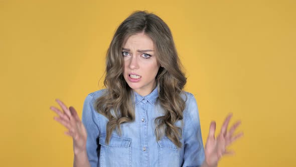 Screaming Angry Young Girl Isolated on Yellow Background alt
