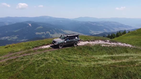 Drone Shot Of Big SUV In Top Of Mountain