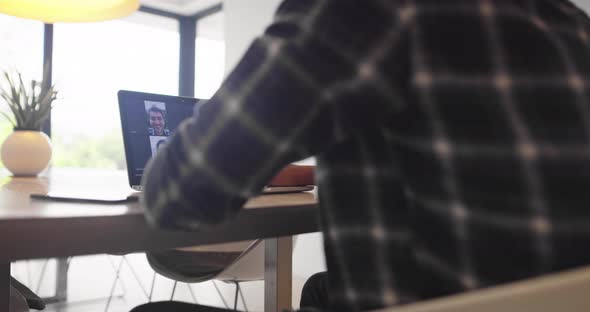African American Businessman Making Online Conference Video Call Using Smartphone and Laptop alt
