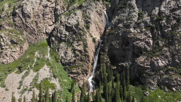 Burkhan Bulak Waterfall in the Mountains in Central Asia alt