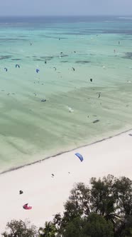 Vertical Video Kitesurfing Near the Shore of Zanzibar Tanzania alt