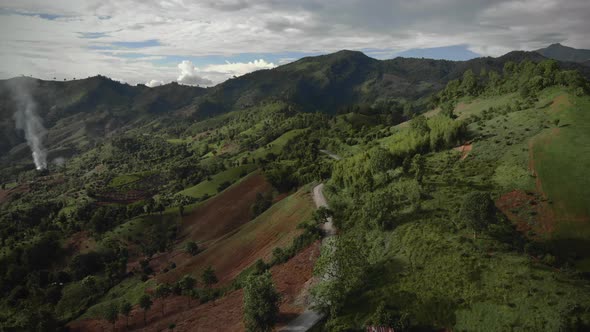 Aerial mountains valley landscape with road during sunet. alt