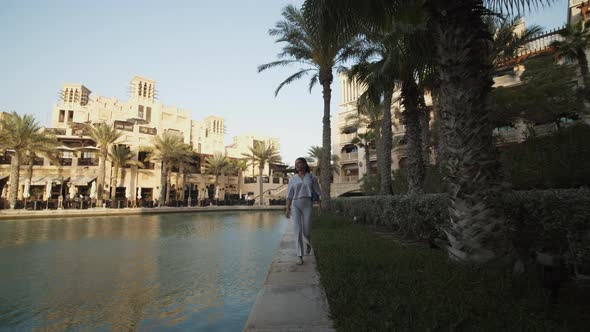 Woman Walking Along the Water in Luxury Residential Neighborhood in Dubai alt