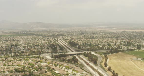 Helicopter aerial shot of landing strips sticking out over ocean, and airport buildings, foggy day alt